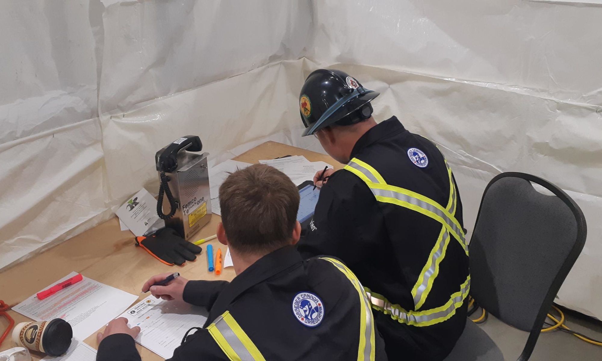 Team members using mine rescue software on a tablet